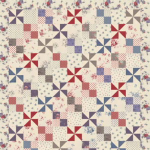 Padstow Range free quilt pattern by Moda Fabrics featuring colorful pinwheel and four-patch blocks in vintage red, blue, lavender, and gray floral fabrics from the Cabbages & Roses collection.